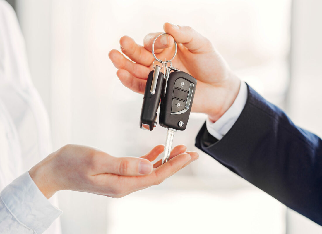 Woman buying the car. Lady in a car salon. Manager with a client